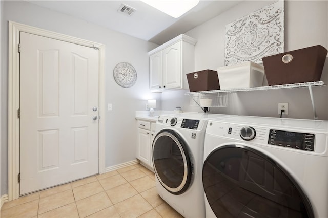 705 SW Maidstone Ave, Bentonville, AR 72712 - laundry room featuring washer and dryer, cabinet space, baseboards, and light tile patterned floors