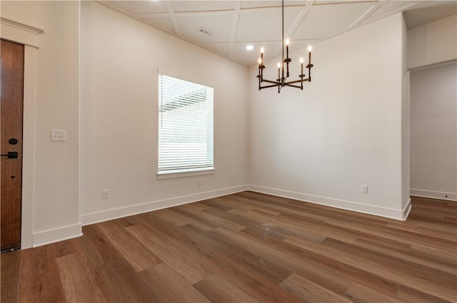 unfurnished room with a chandelier, wood finished floors, baseboards, recessed lighting, and coffered ceiling