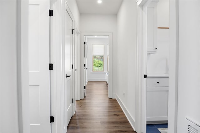 hallway with recessed lighting, dark wood-style floors, baseboards, and visible vents