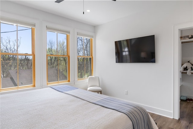 bedroom with recessed lighting, baseboards, and wood finished floors