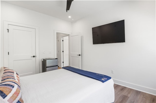 bedroom featuring baseboards, recessed lighting, wood finished floors, and a ceiling fan