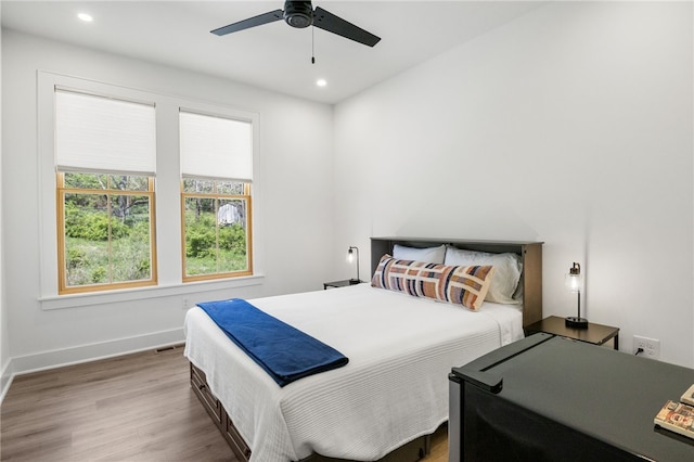 bedroom with visible vents, baseboards, recessed lighting, and wood finished floors