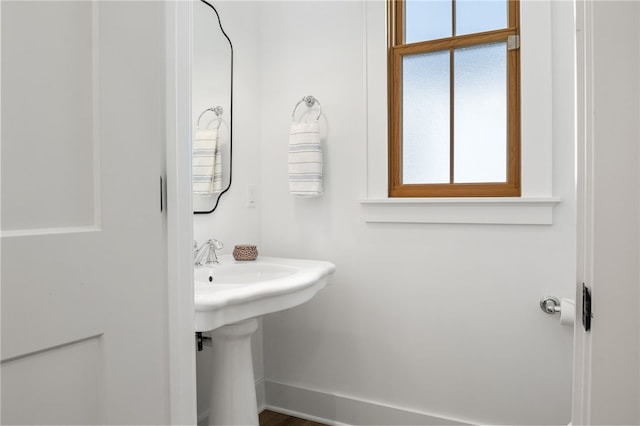 bathroom with a sink and baseboards