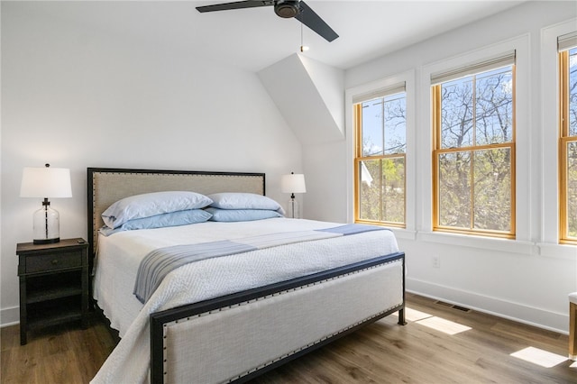 bedroom with visible vents, baseboards, a ceiling fan, and wood finished floors
