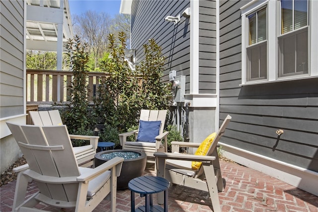 view of patio / terrace featuring an outdoor fire pit