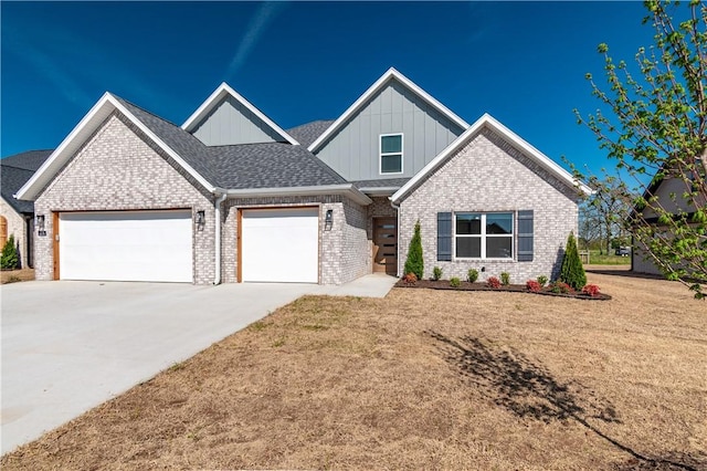 view of front facade featuring board and batten siding, brick siding, an attached garage, concrete driveway, and a front yard