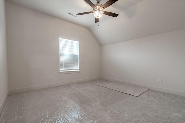 additional living space featuring carpet flooring, lofted ceiling, a ceiling fan, and baseboards