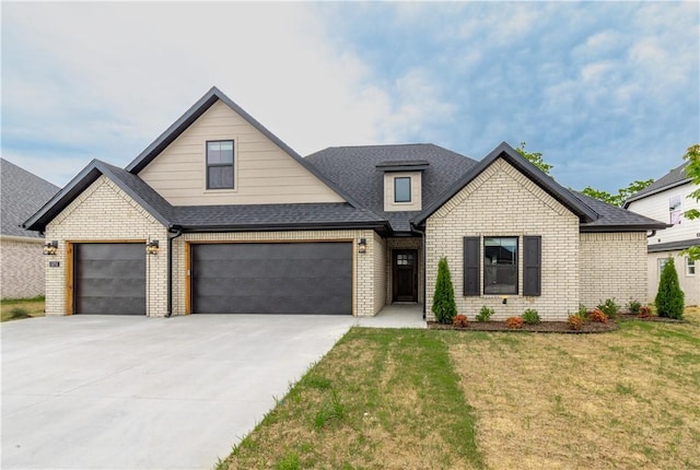 view of front of house with brick siding, driveway, a front lawn, and a shingled roof