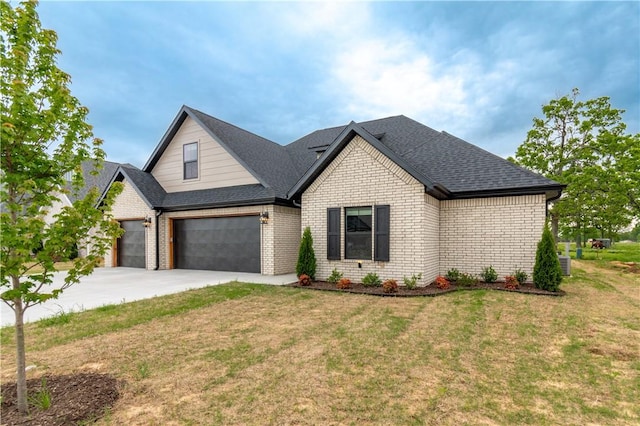 view of front of house with brick siding, a front lawn, concrete driveway, and roof with shingles