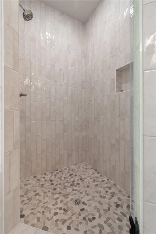 bathroom with tiled shower