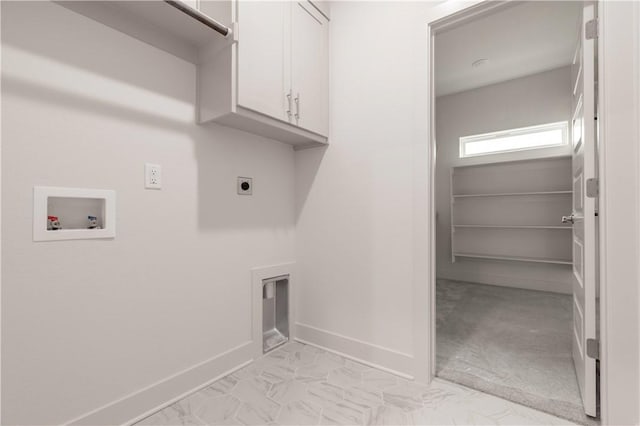 laundry room with cabinet space, hookup for a washing machine, baseboards, and electric dryer hookup