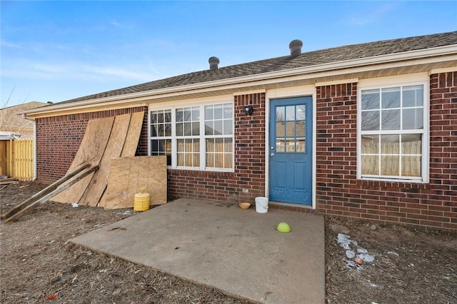 entrance to property featuring brick siding