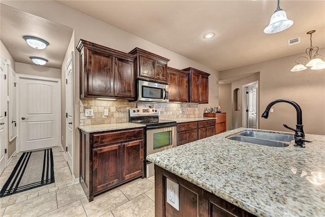 3207 SW Stonepoint Ave, Bentonville, AR 72712 - kitchen with tasteful backsplash, visible vents, a sink, stainless steel appliances, and light stone counters