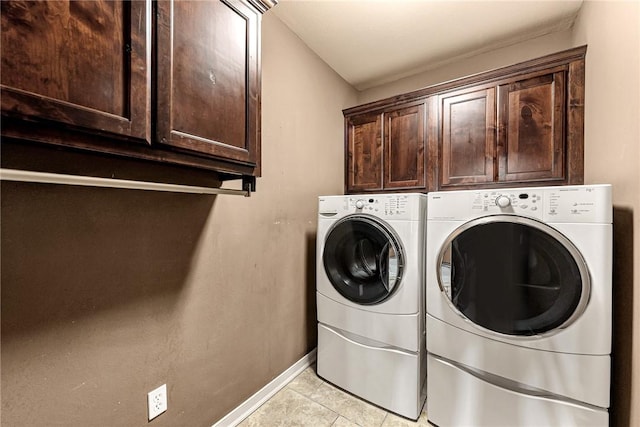 3207 SW Stonepoint Ave, Bentonville, AR 72712 - clothes washing area featuring light tile patterned floors, washing machine and dryer, baseboards, and cabinet space