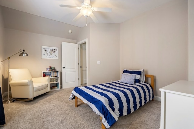 carpeted bedroom with a ceiling fan and vaulted ceiling