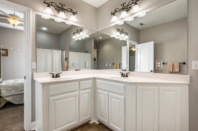 bathroom with a ceiling fan and double vanity
