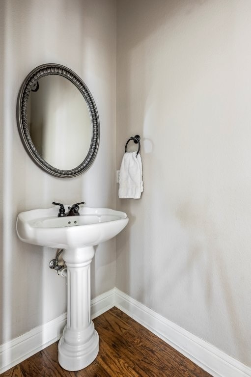 bathroom featuring baseboards and wood finished floors