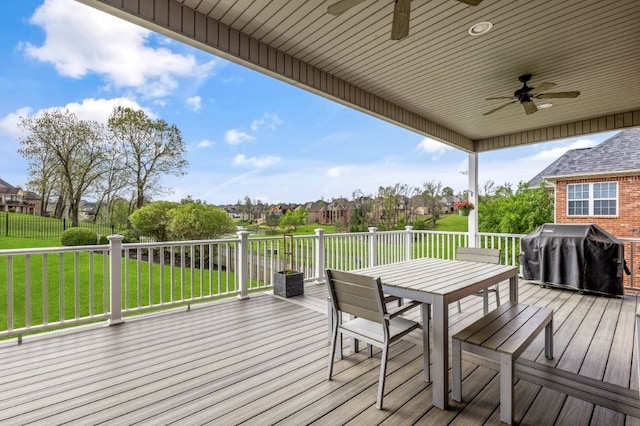wooden deck with ceiling fan, grilling area, a yard, and outdoor dining area