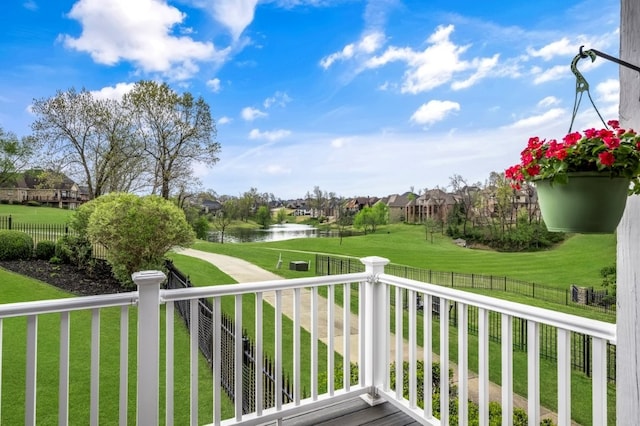 balcony featuring a water view and a residential view