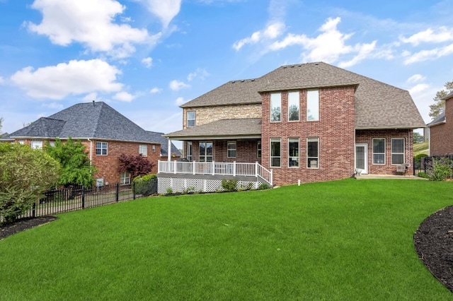 rear view of house featuring brick siding and a shingled roof