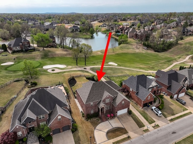 aerial overview of property's location featuring nearby suburban area, a local golf course, and a nearby body of water