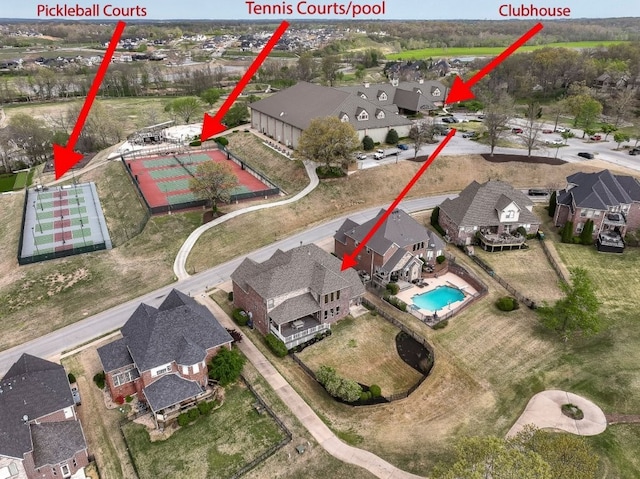 aerial view of property's location with nearby suburban area and a pool