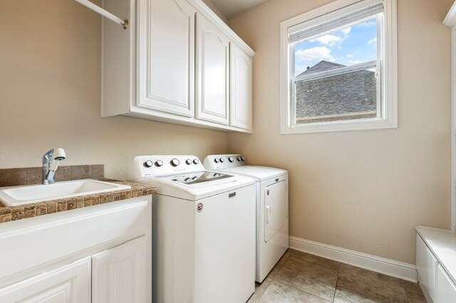 laundry area with cabinet space, washer and clothes dryer, and baseboards
