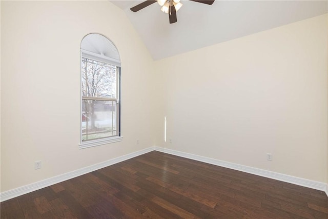 spare room featuring ceiling fan, baseboards, vaulted ceiling, and dark wood-style flooring