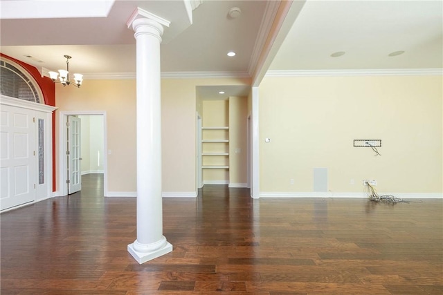 unfurnished living room featuring decorative columns, ornamental molding, a chandelier, wood finished floors, and baseboards