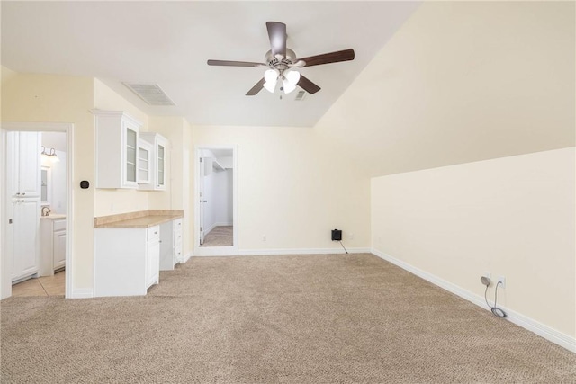 bonus room featuring baseboards, vaulted ceiling, light carpet, a ceiling fan, and visible vents