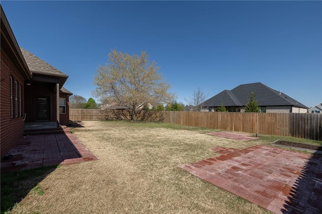 view of yard featuring a patio area and a fenced backyard