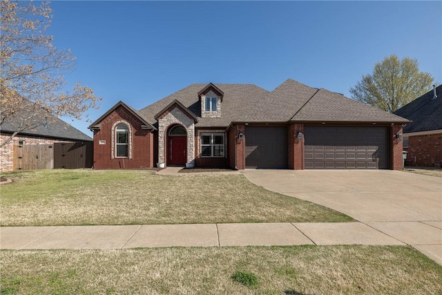 view of front of house with a garage, a front yard, driveway, and brick siding