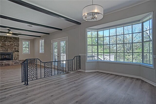 1504 N Hills Blvd, Van Buren, AR 72956 - unfurnished living room featuring wood finished floors, baseboards, a chandelier, ceiling fan, and beamed ceiling
