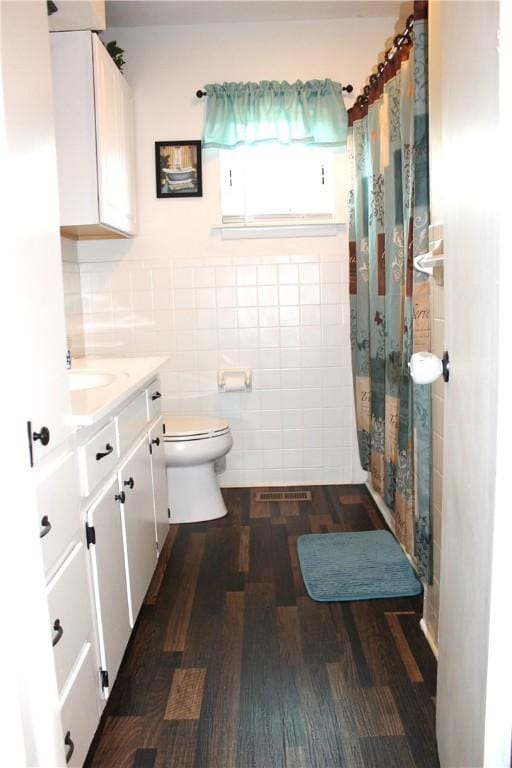 701 Crossbow Rd, Huntsville, AR 72740 - full bathroom with tile walls, toilet, vanity, wood finished floors, and curtained shower