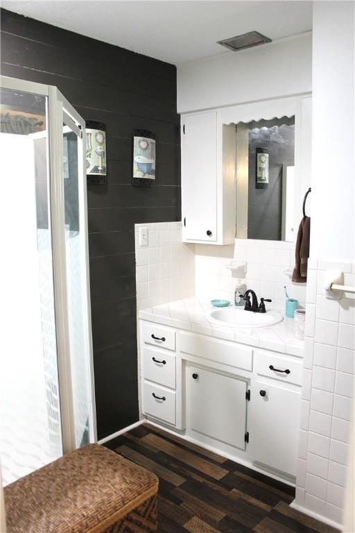 701 Crossbow Rd, Huntsville, AR 72740 - bathroom with vanity, wood finished floors, backsplash, and a shower stall