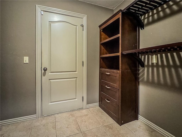 spacious closet featuring light tile patterned flooring