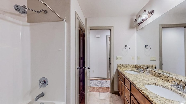 full bath featuring double vanity, a sink, tile patterned flooring, and  shower combination