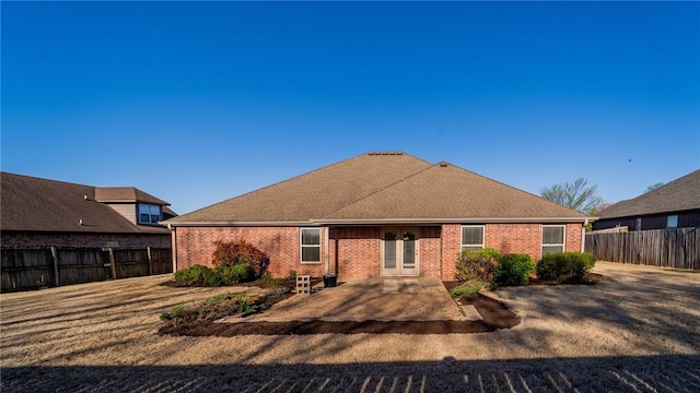back of house featuring brick siding, a patio area, and a fenced backyard