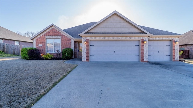 view of front of home with a garage, brick siding, and concrete driveway