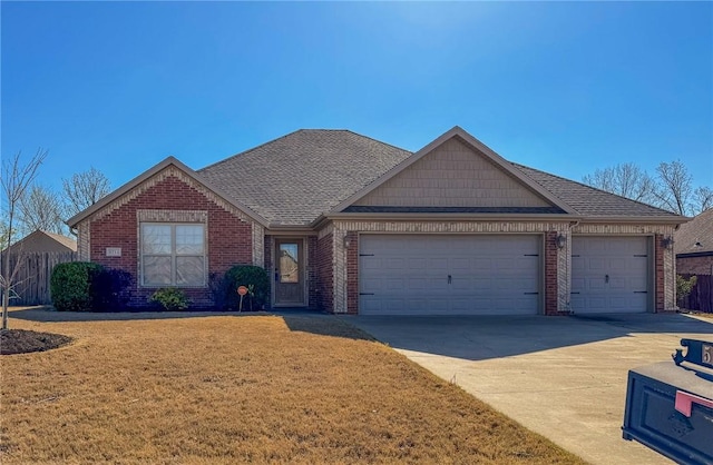 single story home featuring a front lawn, driveway, brick siding, an attached garage, and a shingled roof