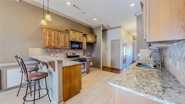 kitchen featuring visible vents, a sink, crown molding, black microwave, and stainless steel gas range oven