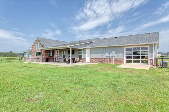 back of property featuring cooling unit, a yard, a patio, fence, and brick siding