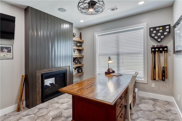 office space with a multi sided fireplace, baseboards, visible vents, and recessed lighting