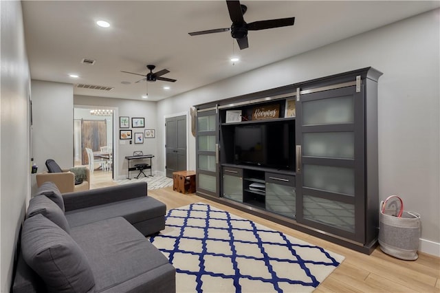 living room with visible vents, recessed lighting, a ceiling fan, and light wood-style floors