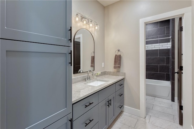 bathroom featuring marble finish floor, vanity, and baseboards