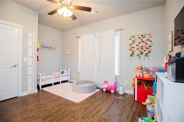 playroom featuring visible vents, baseboards, wood finished floors, and ceiling fan