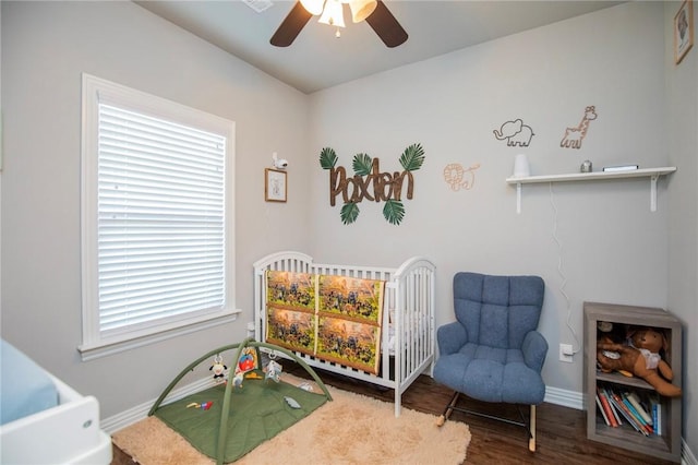 bedroom with ceiling fan, wood finished floors, and baseboards