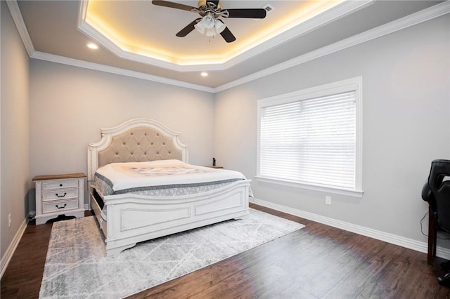 bedroom featuring dark wood-style flooring, baseboards, a raised ceiling, and recessed lighting
