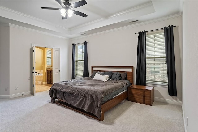 bedroom with a raised ceiling, crown molding, light colored carpet, and visible vents