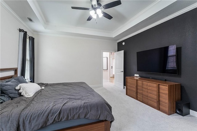 carpeted bedroom featuring visible vents, a tray ceiling, and crown molding
